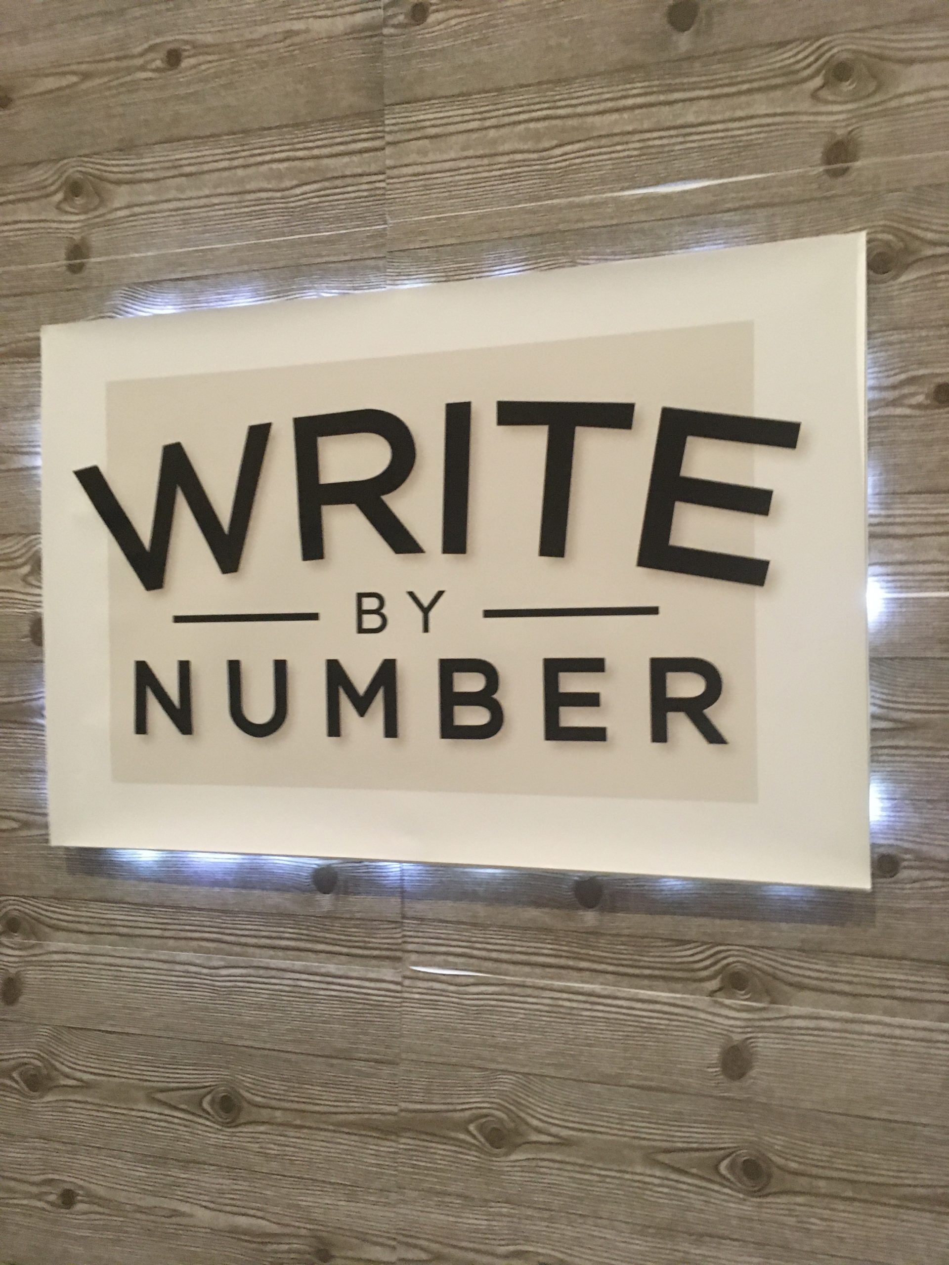 Write by Number exhibit booth sign